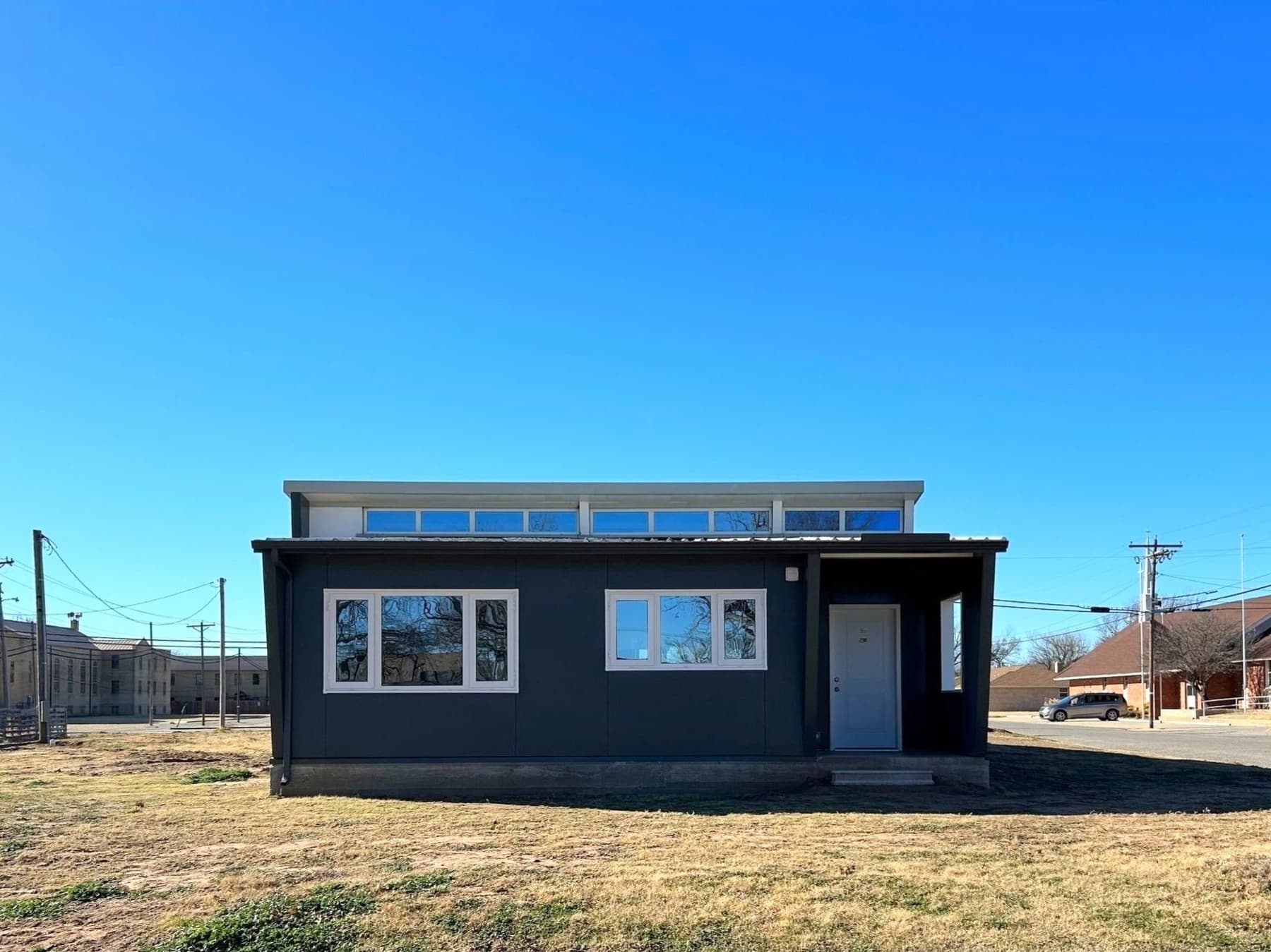The completed 2-bedroom Zona Verde home in Watonga, Oklahoma, with charcoal exterior and clerestory windows